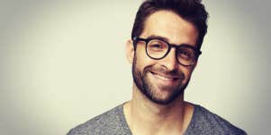 handsome man smiling in glasses