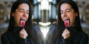 woman with lollipop in her mouth