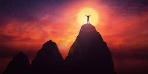success overcoming obstacle person standing on top of mountain