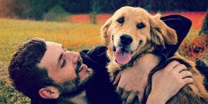 man and dog play in a field, dog thinks man is evil