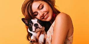 woman cuddling dog