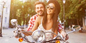 happy smiling couple on moped