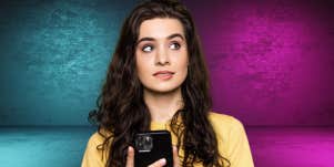 woman confused surprised holding phone