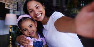 mom taking selfie with daughter