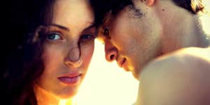 woman looking at camera with man next to her
