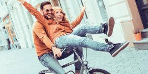 couple on bike together having fun