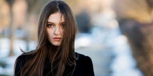 woman with dark hair facing camera