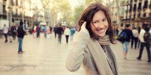 happy and energetic woman in winter cityscape