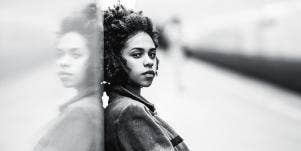 woman leaning against wall 