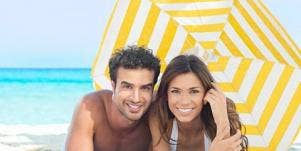 couple under umbrella on beach