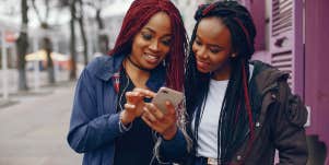 2 women looking at phone
