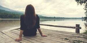 woman sitting by herself on beach