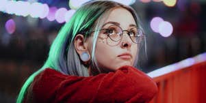 woman with blue hair looking up