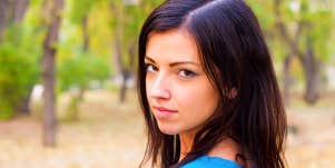 Young woman looks intensely at the camera.