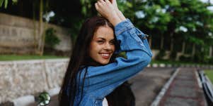 confident smiling woman in jean jacket