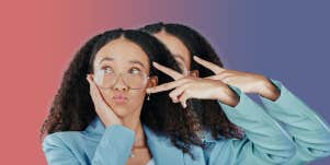 Woman wearing glasses making a peach sign