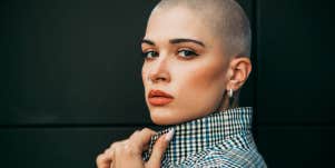 confident woman with shaved head in blazer