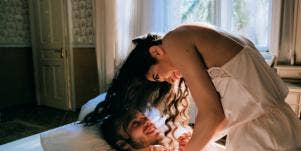 man and woman in bed laughing