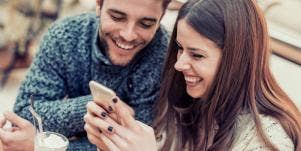 couple laughing playing on phone together