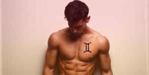 man with gemini symbol tattoo on chest