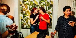 flirty couple at a party kissing 