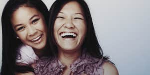 mom and teen daughter laughing