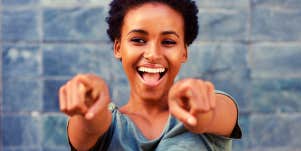 smiling woman pointing at the camera