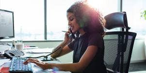 woman at desk typing working