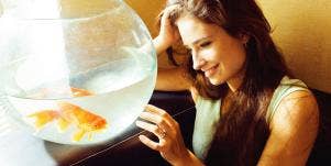woman staring at goldfish