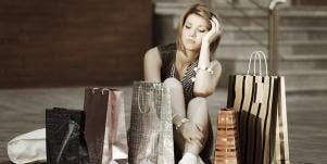 woman sitting on the floor with shopping bags