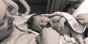 woman holding baby after giving birth