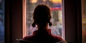 woman looking out a window