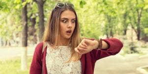 woman running late looking at watch