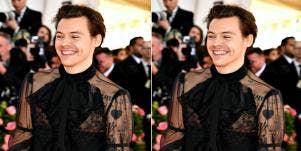 Harry Styles wears a lacy black top, his tattoos showing through
