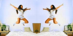 woman jumping on bed
