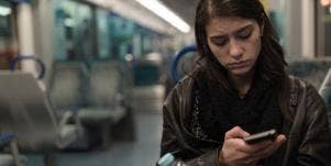unhappy woman looking at memes on phone
