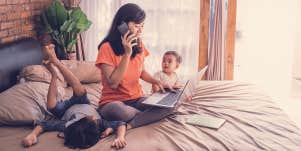 woman working at home with 2 kids around