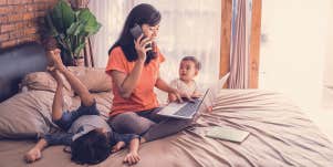 woman working at home with 2 kids around