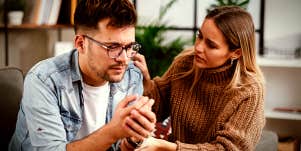 wife talking to her husband, who is crying