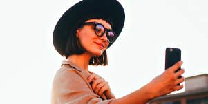 girl taking selfie with phone