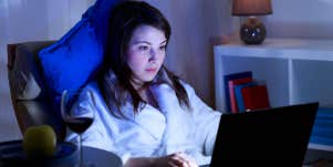 woman on computer in dark