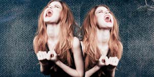 Angry woman, screaming out while clenching her fists in release