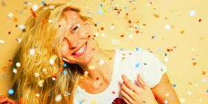 happy woman surrounded by confetti