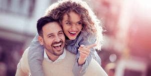man carrying woman on his back
