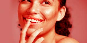 woman exfoliating her lips
