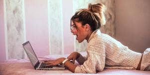 shocked woman looking at laptop