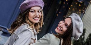 women smiling in berets