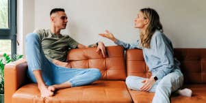 unhappy couple arguing on the couch