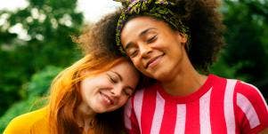 Two women smiling and hugging