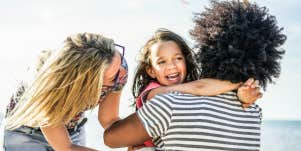 family hugging on a beach